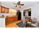 Functional kitchen features wooden cabinets, black appliances, and an adjacent dining area at 613 S Mickley Ave, Indianapolis, IN 46241