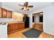 Functional kitchen featuring wooden cabinets, black appliances, and an adjacent dining area at 613 S Mickley Ave, Indianapolis, IN 46241