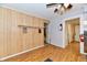 Open-concept kitchen with wood-paneled wall and laminate flooring at 613 S Mickley Ave, Indianapolis, IN 46241