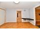 Bright living room with wood-look floors, neutral walls, and doorways to other spaces at 613 S Mickley Ave, Indianapolis, IN 46241