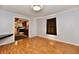 Inviting living room with wood-look floors, neutral paint, and easy access to other rooms at 613 S Mickley Ave, Indianapolis, IN 46241