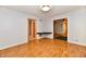 Open living room with wood-look floors, neutral paint, and easy access to other rooms at 613 S Mickley Ave, Indianapolis, IN 46241