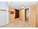 View of an empty room with wood paneling and carpeted floor at 613 S Mickley Ave, Indianapolis, IN 46241