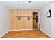 View of an empty room with wood paneling and linoleum floors at 613 S Mickley Ave, Indianapolis, IN 46241