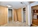 View of an empty room with wood paneling and carpeted floor at 613 S Mickley Ave, Indianapolis, IN 46241