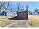 Wooden backyard shed offers additional storage, surrounded by mature trees at 613 S Mickley Ave, Indianapolis, IN 46241