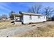 A quaint single-story home with a concrete driveway and small covered patio at 613 S Mickley Ave, Indianapolis, IN 46241