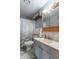 Bathroom with white vanity, toilet, shower with patterned curtain, and tiled floor at 6404 W Ray St, Indianapolis, IN 46241