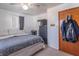 Neutral bedroom features a soft gray comforter, a window, and a closet in view at 6404 W Ray St, Indianapolis, IN 46241