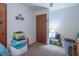 Bedroom showcasing toys, wood door, small lamp, and neutral paint at 6404 W Ray St, Indianapolis, IN 46241