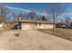 Cozy one-story brick home with a concrete driveway and a well-kept front yard at 6404 W Ray St, Indianapolis, IN 46241