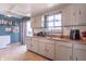 Efficient kitchen featuring plenty of storage, a double sink, and an open view to the outdoor space at 6404 W Ray St, Indianapolis, IN 46241