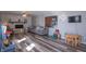 Spacious living room with stylish flooring, a stone fireplace, and a comfortable seating arrangement at 6404 W Ray St, Indianapolis, IN 46241
