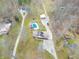 Aerial view of the home, pool, detached garage and circular driveway surrounded by nature at 6602 S 400 W, Columbus, IN 47201