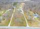 Aerial view showcasing several homesites on large wooded lots and gravel drives at 6602 S 400 W, Columbus, IN 47201