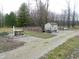 View of the backyard shed and fenced garden area off the gravel drive at 6602 S 400 W, Columbus, IN 47201