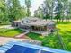 Aerial backyard view with wooden deck, mature trees, and well-maintained lawn at 6602 S 400 W, Columbus, IN 47201