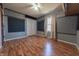 Bedroom with hardwood floors, closet, fan, and customized wall panels at 6602 S 400 W, Columbus, IN 47201
