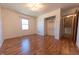 Bedroom featuring hardwood floors, a closet, and bright, natural lighting at 6602 S 400 W, Columbus, IN 47201