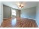 Spacious bedroom with wood-look floors, ceiling fan, and a window providing natural light at 6602 S 400 W, Columbus, IN 47201
