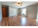 Bedroom featuring wood-look floors, ceiling fan, and a window providing natural light at 6602 S 400 W, Columbus, IN 47201