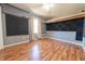 Bedroom with hardwood floors, closet, fan, and customized wall panels at 6602 S 400 W, Columbus, IN 47201