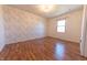 Bedroom featuring hardwood floors and patterned wallpaper at 6602 S 400 W, Columbus, IN 47201