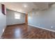 Comfortable bedroom with neutral gray walls, wood-look flooring, and a window for ample natural light at 6602 S 400 W, Columbus, IN 47201