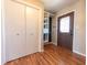 Front entry with a closet, wood floors, and view of the custom shelving at 6602 S 400 W, Columbus, IN 47201
