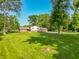 Beautiful front yard view, showcasing the home and lush landscaping and mature trees at 6602 S 400 W, Columbus, IN 47201