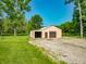 Metal outbuilding featuring large garage doors and a well maintained lawn at 6602 S 400 W, Columbus, IN 47201
