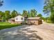 Exterior view of the brick home highlighting the attached garage and parking area at 6602 S 400 W, Columbus, IN 47201