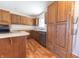 A kitchen with custom wood cabinets, stainless steel appliances, and laminate floors at 6602 S 400 W, Columbus, IN 47201