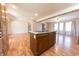Spacious kitchen with a large island and laminate wood flooring flowing into the living space at 6602 S 400 W, Columbus, IN 47201