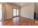 Bright living room with wood flooring and glass sliding door access to the backyard at 6602 S 400 W, Columbus, IN 47201