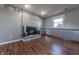 Cozy living room showcasing a brick fireplace, wood-look flooring and bright natural light at 6602 S 400 W, Columbus, IN 47201