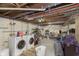 Unfinished basement laundry area with washer and dryer, ready for customization at 715 S Ribble Ave, Muncie, IN 47302