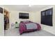 Bedroom featuring a queen sized bed, side table, and black-out curtains at 715 S Ribble Ave, Muncie, IN 47302