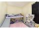 bedroom with bunk bed, slide, pink rug, and play kitchen at 715 S Ribble Ave, Muncie, IN 47302
