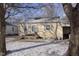 Charming single-story home with a covered carport and partially snow-covered front yard at 715 S Ribble Ave, Muncie, IN 47302