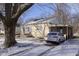 Inviting single-story home with an attached carport and a snow-dusted driveway at 715 S Ribble Ave, Muncie, IN 47302