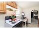 Cozy kitchen featuring wood cabinets, white appliances, and a small table for casual dining at 715 S Ribble Ave, Muncie, IN 47302