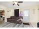 Comfortable living room featuring a ceiling fan, cozy sofa, and neutral decor at 715 S Ribble Ave, Muncie, IN 47302