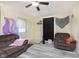 Well-lit living area with a comfortable couch and a ceiling fan at 715 S Ribble Ave, Muncie, IN 47302