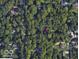 An aerial view shows this home nestled among lush trees in a serene, private setting at 7971 Conarroe Rd, Indianapolis, IN 46278