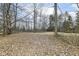 View of the backyard featuring fallen leaves and mature trees at 7971 Conarroe Rd, Indianapolis, IN 46278