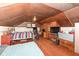 Slanted ceiling attic bedroom featuring twin beds, workspace, and wood flooring at 7971 Conarroe Rd, Indianapolis, IN 46278