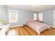 Charming bedroom with polka dot accent wall, hardwood floors, and a cozy bed at 7971 Conarroe Rd, Indianapolis, IN 46278