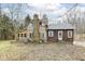 Rear exterior of the home with chimney and enclosed porch at 7971 Conarroe Rd, Indianapolis, IN 46278