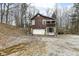 Rustic home exterior with a garage, unique facade, and natural surroundings at 7971 Conarroe Rd, Indianapolis, IN 46278